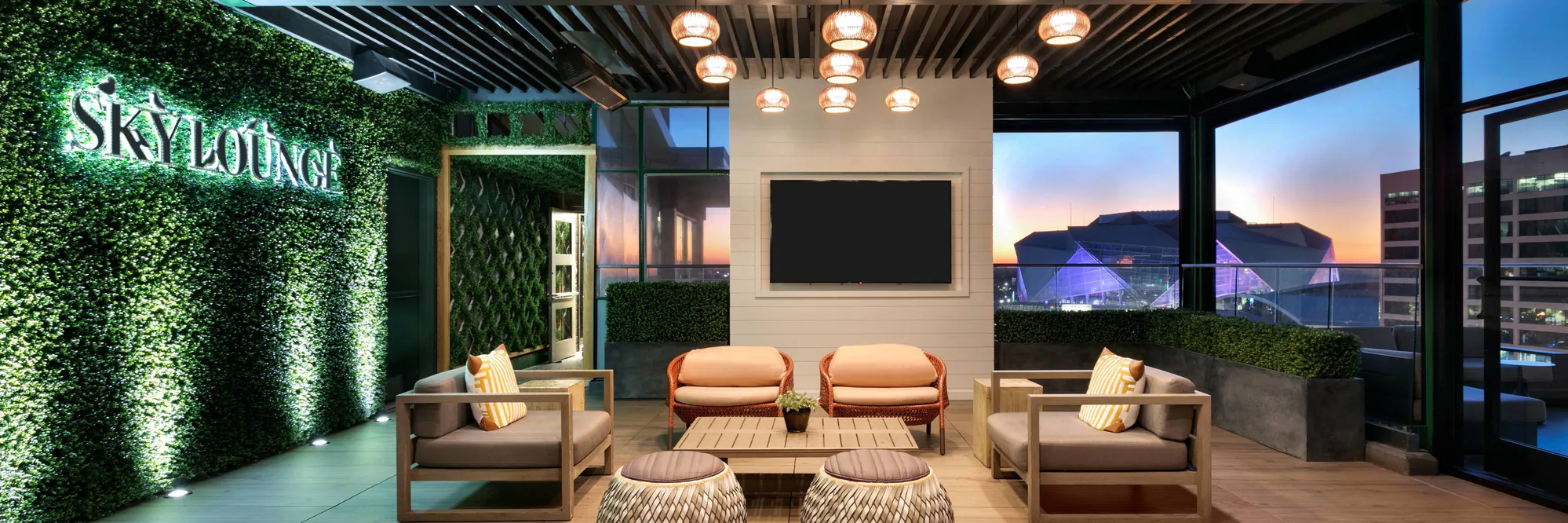 SkyLounge sign and seating area at dusk