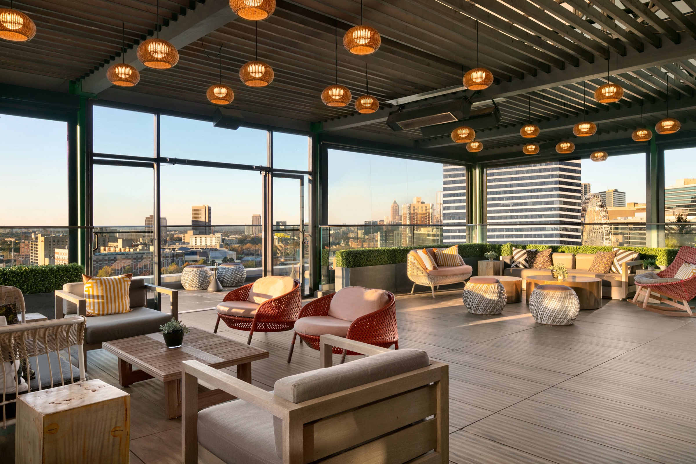 SkyLounge rooftop seating with the Atlanta skyline at golden hour